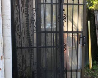 Close up of black iron screen doors