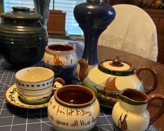 Torquay/motto ware. English pottery ca. 1900’-1930’s. Also called ‘motto ware’ for the sayings “See a pin, let it stay
Bad luck yours all the day”. 
The teapot says “Droon (drown) yer sorrows in a cup o’ tea”!