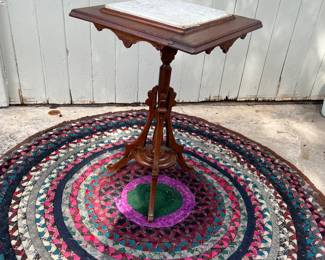 Victorian side table with marble top, and one of several rugs. 