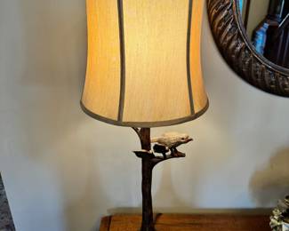 Unique wood cabinet with leaf “pulls” and metal bird on a branch lamp