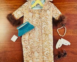 1961 Bubble Cut Titian Red Hair Barbie with original striped swimsuit, Barbie Doll Case and 10 outfits.  Outfits include ‘Evening Splendor’, ‘Friday Night Date Night’, ‘Solo In The Spotlight’, ‘Winter Holiday’, ‘Nighty Negligee’ and more.  There are a few additional accessories & shoes.  THIS WILL BE SOLD AS ONE LARGE COLLECTION. 