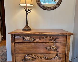 Unique wood cabinet with leaf “pulls” and metal bird on a branch lamp