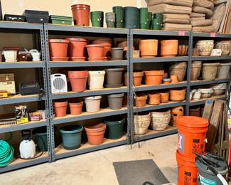 Full garage, including a large assortment of concrete, terracotta, plastic & composite pots and planters