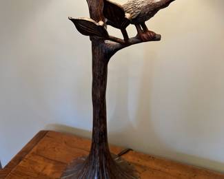 Unique wood cabinet with leaf “pulls” and metal bird on a branch lamp
