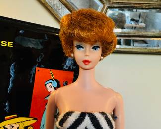1961 Bubble Cut Titian Red Hair Barbie with original striped swimsuit, Barbie Doll Case and 10 outfits.  Outfits include ‘Evening Splendor’, ‘Friday Night Date Night’, ‘Solo In The Spotlight’, ‘Winter Holiday’, ‘Nighty Negligee’ and more.  There are a few additional accessories & shoes.  THIS WILL BE SOLD AS ONE LARGE COLLECTION. 