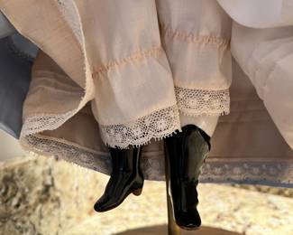 Antique 21” porcelain doll on stand