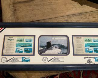 Naval stamps and postcard in a frame