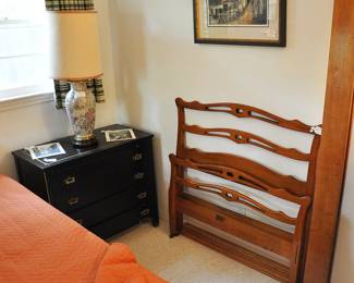 One of 2 ebony side tables with a shelf that pulls out to hold things, plus a attractive twin bed with matching rails