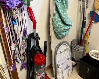 Vacuum, ironing board, mops and brooms