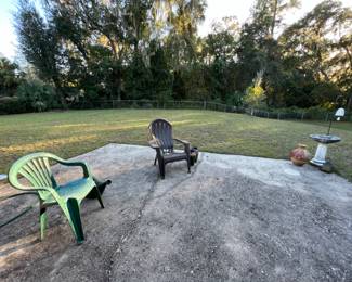 Plastic patio chairs, bird bath, bell on shepherd hook, pots