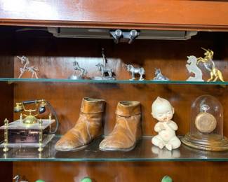 Unicorn figurines made from pewter and glass, antique shoes, jewelry storage.