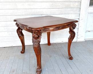 ANTIQUE MAHOGANY CARVED END TABLE WITH LION DETAIL AND SCALLOPED EDGE