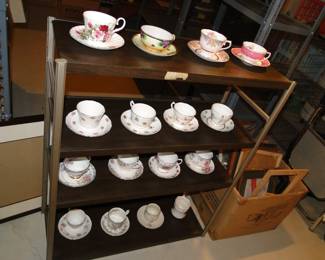Lots of tea cups on display on the metal shelf