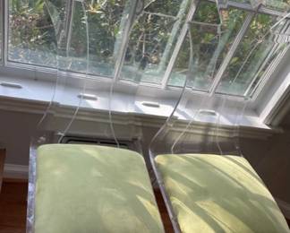 Pair of lucite chairs with cushions.


