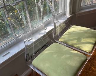 Pair of lucite chairs with cushions.