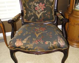 Dark wood chair accentuated with rich fabric