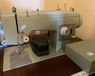 vintage Kenmore sewing machine in cabinet 