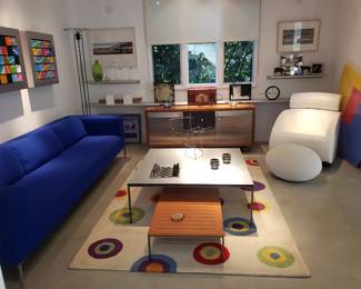 Den.  Coffee Table and Bench probably by Balthaup.  Pair of white leatehr rockers by Ligne Roset, and the Royal Blue sofa probably is