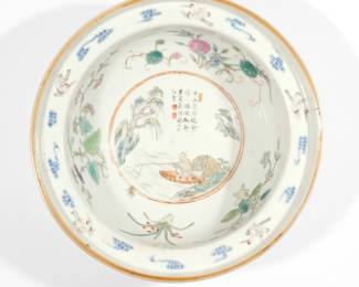 CHINESE FAMILLE ROSE PORCELAIN BOWL | Qing dynasty, 19th century, the interior with insects among flowers centering a man in a boat with calligraphy, the rim with cranes among clouds, the exterior with scrolling flowers, with gallery labels indicating Tongzhi reign (1862-1874) production. h. 3-1/4 dia. 8-5/8 in.