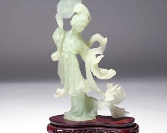 CHINESE QING DYNASTY PALE CELADON JADE GUANYIN | Quan Yin, on a conforming carved wood stand. h. 8 w. 5 in. (jade only). Overall: h. 9-1/2 x 6 in. (on stand)