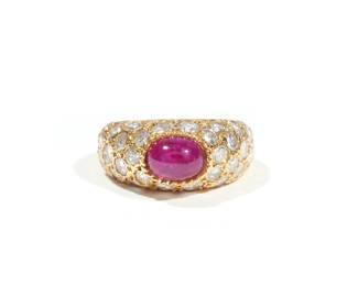 VAN CLEEF & ARPELS DIAMOND, RUBY & 18K LADIES RING | With cabochon ruby (approx. 0.90 ct) surrounded by melee diamonds set in 18k yellow gold (diamonds approx. 1.19 cttw), marked VCA and numbered inside the band; size 1/75, 3.7g