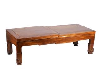 UNUSUAL CHINESE ROSEWOOD LOW TABLE | Possibly Huanghuali, with a slightly stepped paneled top, conforming apron, and relief-carved feet. h. 12 w. 39 d. 17-1/4 in.