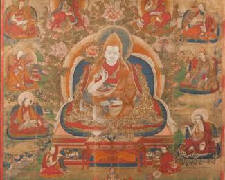 TIBETAN THANGKA, 18TH CENTURY | Seated figure with attendants. Opaque pigment on fabric. h. 28-1/4 w. 25 in. Depicting a seated white-skinned teacher figure, possibly Padmasambhava or Tsongkhapa, wearing a cap, holding a lotus in one hand and a manuscript in his lap, surrounded by flowers and attendants, with inscriptions lower margin and throughout. Overall: 29-3/4 x 26-1/4 in. (frame)