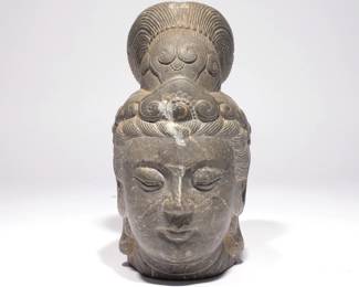 CHINESE STONE CARVED HEAD OF GUANYIN | Mottled grey stone, the Goddess of Mercy, well articulated and depicted with headdress and downcast eyes. h. 10-1/2 w. 6 d. 5-1/2 in.