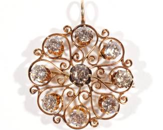 DIAMOND & 14K GOLD BROOCH/PENDANT | Having nine 0.60ct. old mine-cut diamonds (approx. 5.4cttw) in a gold filigree openwork surround, color range I-J, clarity I1-I2, with articulated bail, signed 14k on the brooch clasp; 9.6g