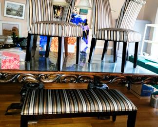Large Carved Wood Dining Table with protective glass top.  4 parsons Chairs AND bench providing seating for 6 