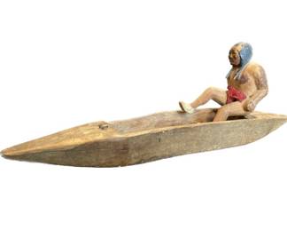 Hand Carved Native American figurine in carved wooden canoe