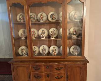 LARGE SOLID WOOD CHINA CABINET SHOWCASING ALL OF THE HUMMELS