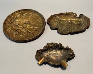 Three Bronze Trays - One Decorated With A Tiger, One Decorated With Hunting Dogs And One Ash Tray