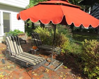 Metal lounge chairs and umbrella
