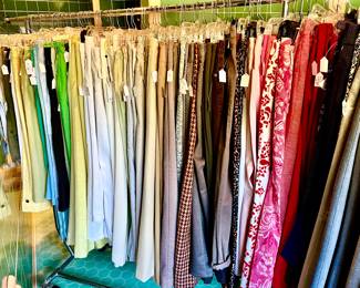 TWO RACKS OF STYLISH PANTS.