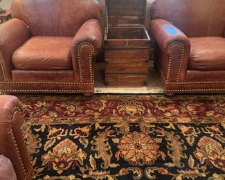 Leather studded brown furniture 
Rugs throughout home 