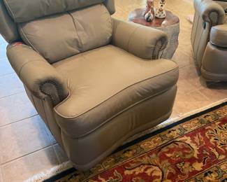 A pair of leather recliners swivel 