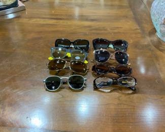 Assortment of like new sunglasses.