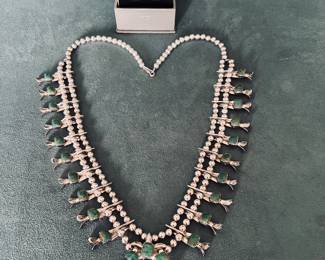 WOW! This beautiful “Squash Blossom” is a must see! Signed  by designer and features  matching earrings, is designed and made by the Navajo Indians Brethtakingly Beautiful!