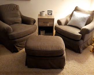 These arm chairs swivel and the ottoman is on wheels!