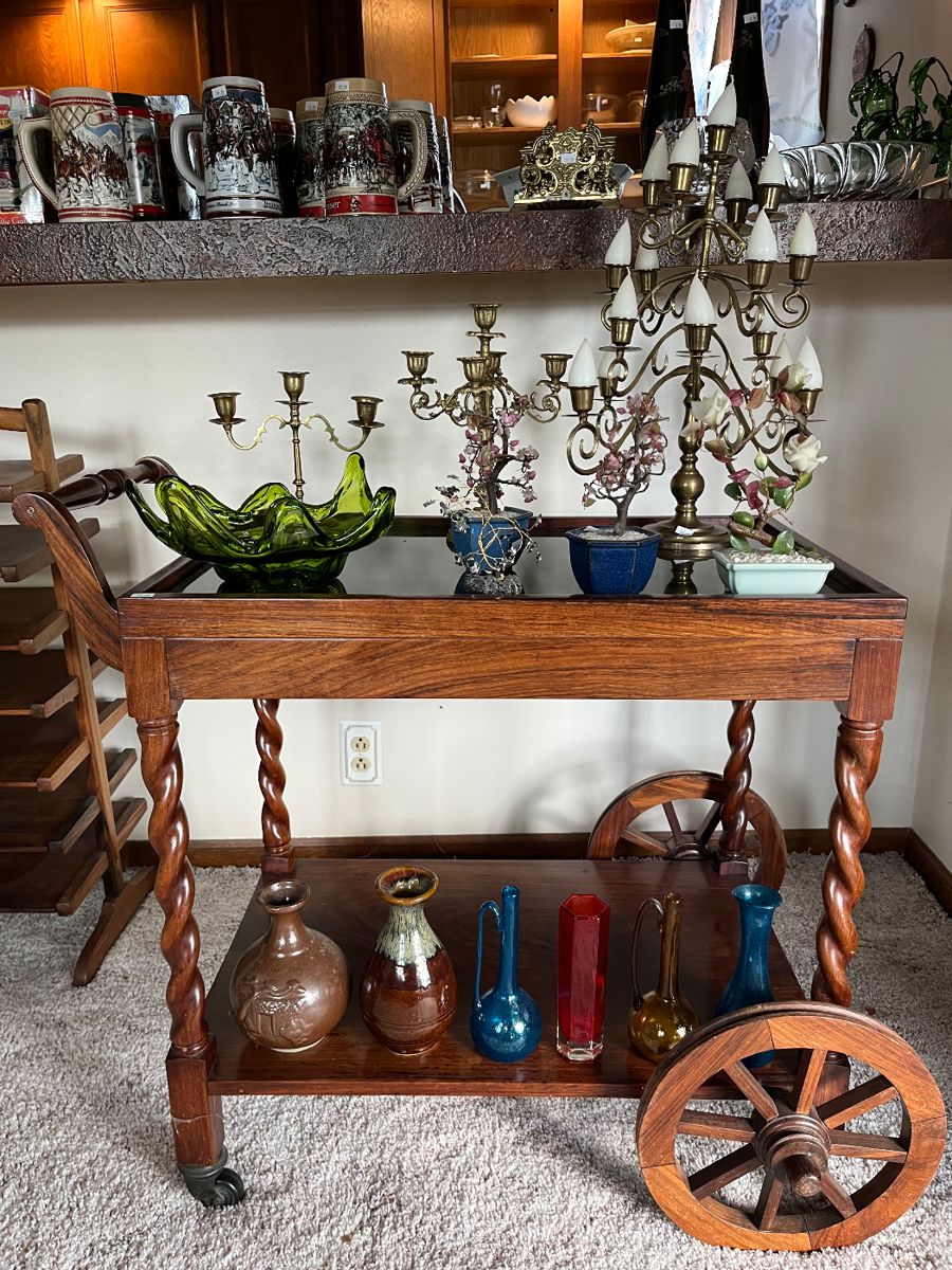 Vintage tea cart with glass top; sale full of quality collectibles, decor and curiosities from around the world.