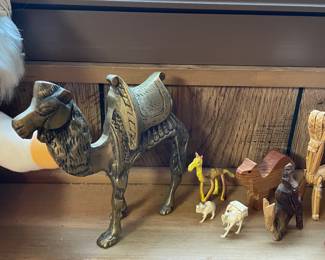 Collection of camel figurines in various styles and materials.