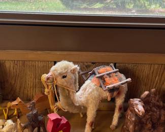 Collection of camel figurines in various styles and materials.