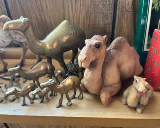Collection of camel figurines in various styles and materials.