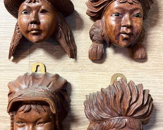 Collection of carved wood head figures, Native American theme.