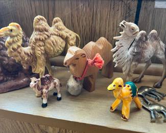 Collection of camel figurines in various styles and materials.