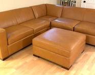 Room and Board Leather Sectional with Coordinating Ottoman measures 32 inches tall and 36 inches deep. The right and left sides measure about 106 inches.  Item is in used condition with some wear including some slight surface scratch marks