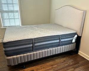 Neutral Queen Bed Frame and  Fabric Headboard with Rivet Detailing. The headboard measures 72 x 18 x 37 inches. 