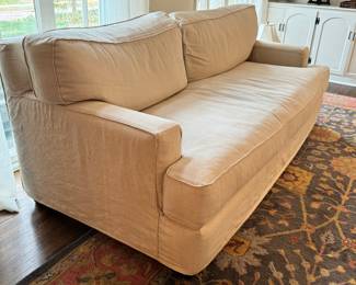 Luxurious Quatrine Furniture Linen Sofa. A truly luxurious comfortable sofa in a fabulous neutral color to match any home decor! Due to the lighting, it was difficult to photograph. It is a very lovely sofa.

The slip cover is removable/washable and replacements can be ordered from Quatrine

Some light fraying/loose threads around the edges/corners likely caused by cat scratches. The loose threads an easily be trimmed. 

Measures 83" l x 40" deep.