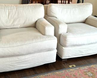 Pair of Quatrine Furniture Linen Arm Chairs. Very comfortable chairs in a nice neutral color. They match the sofa in lot 4 and are in very good condition with some light wear to the edges where there are loose threads which could be trimmed. 

The slip cover is removable/washable and replacements can be ordered from Quatrine

Each measures 41" x 43" x 32.5" 